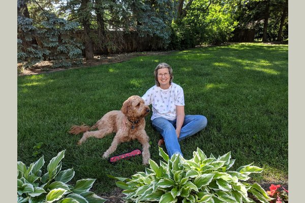 One of our residents with her best friend, Teddy. He is our on site therapy dog!
